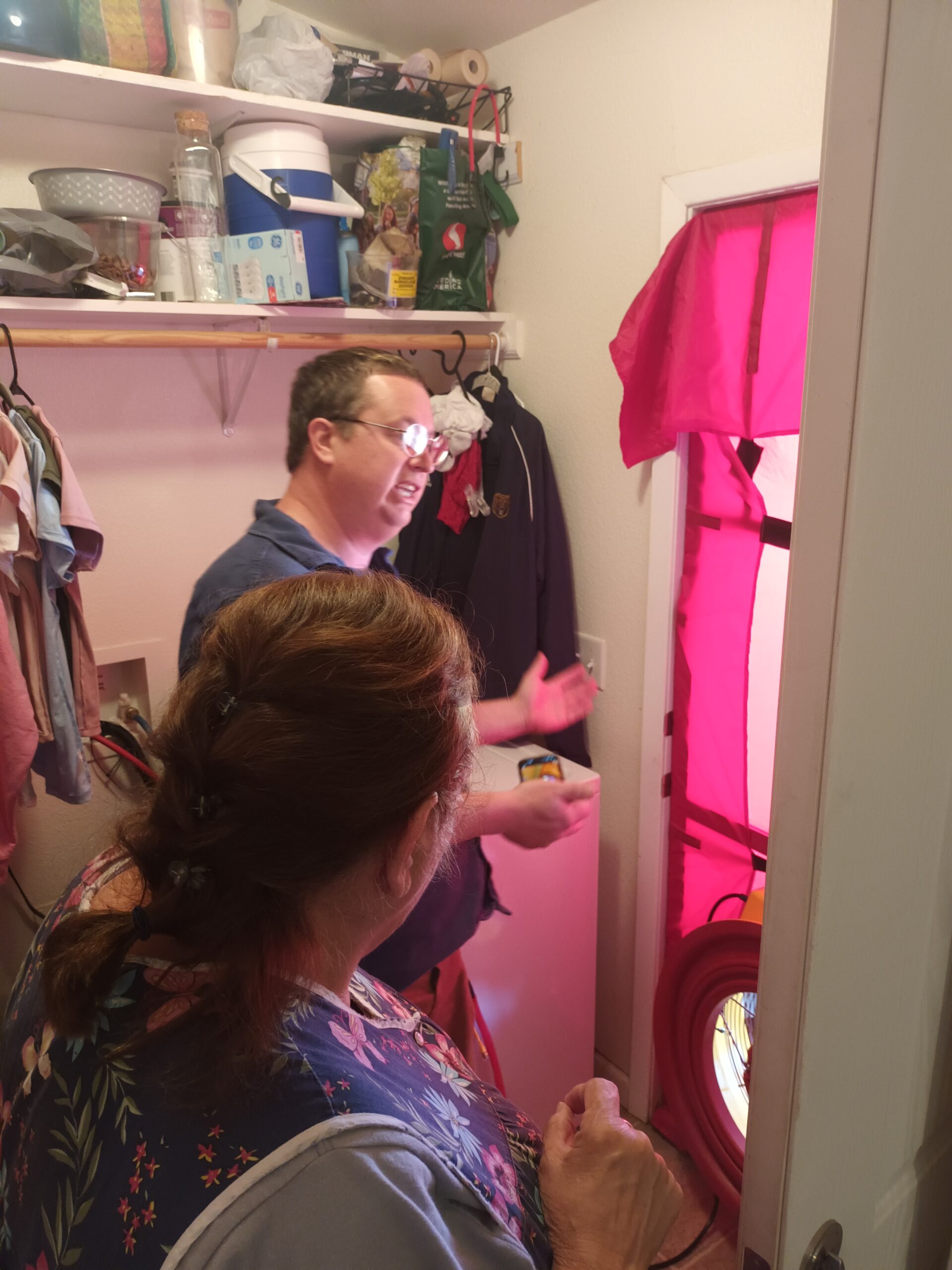 Kent Thompson explains the blower door test to a homeowner in Hopland